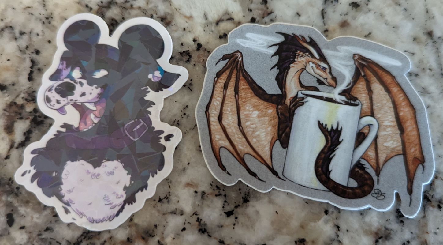 A small dragon with coffee sticker and a dog sticker from a friend.